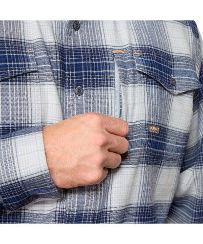 Close-up view of the button flap chest pockets featuring the hidden pen slot and additional zipper chest pocket