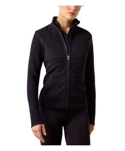 woman wearing a dark navy zip up jacket with a white background