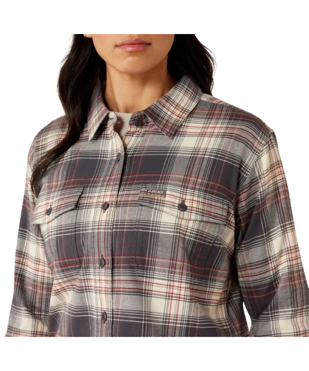 Close-up view of the women's long sleeve flannel work shirt featuring the chest pockets and grey and white plaid print