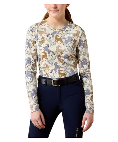 Girl with long sleeve shirt with brown, tan, gray/blue, and indigo horses all over with a black belt and navy equestrian pants