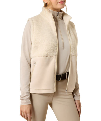 Front view of the girl's almond milk/cream Ariat Laviolette Full Zip Vest featuring the mock collar, cozy sherpa fabric, and zippered hand pockets