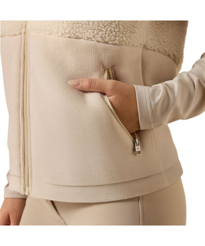Close-up view of the cream sherpa fabric and zippered hand pockets