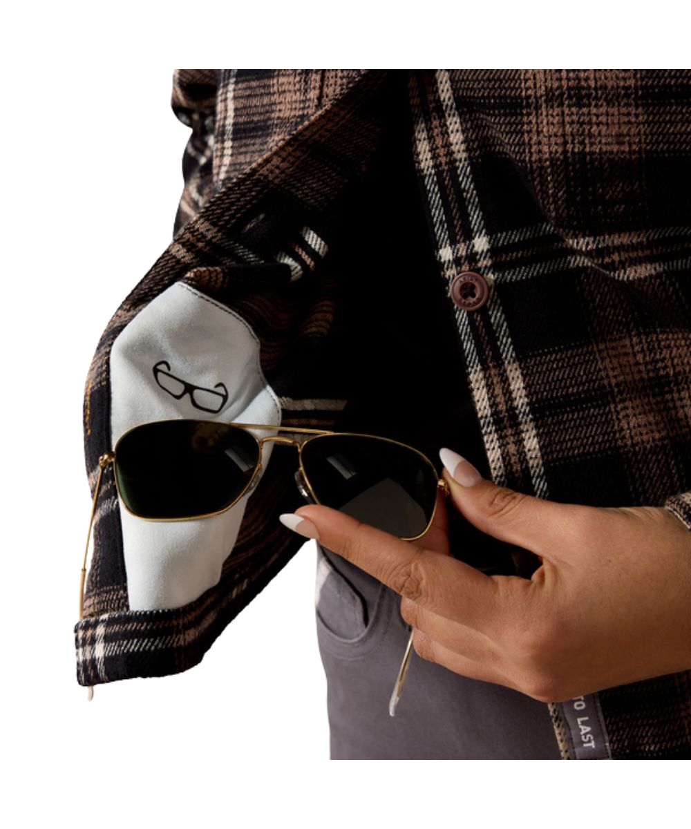 Close-up view of the slightly cropped hem featuring the hidden microfiber lens cloth for on-the-go cleaning
