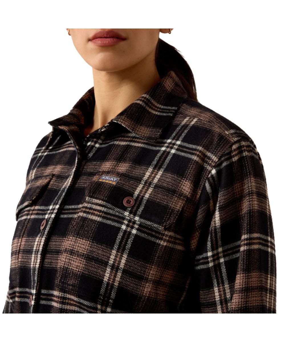 Close-up view of the women's black work shirt featuring the plaid print, spread collar, relaxed fit, and button-through flap chest pockets