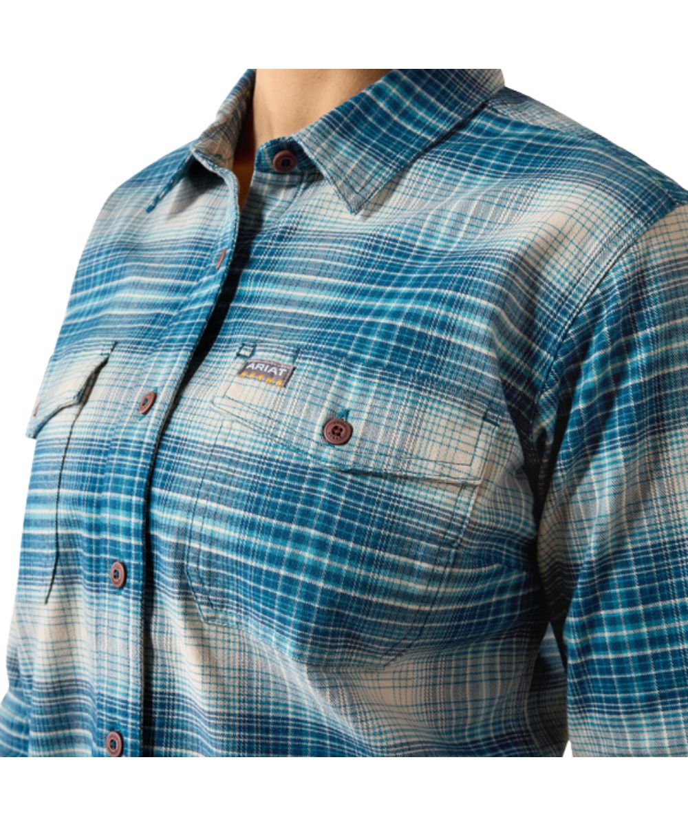 Close-up view of the women's blue and white flannel plaid long sleeve work shirt featuring the chest pockets with a hidden pen slot
