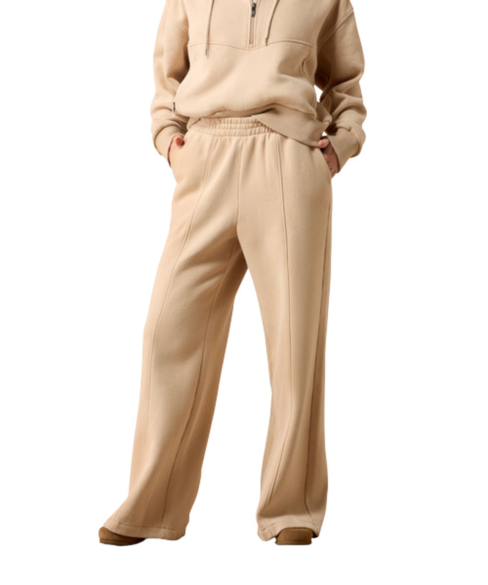 Front view of the women's Ariat Compass Pants featuring moonstone beige/tan color, elastic waistband, and side seam hand pockets