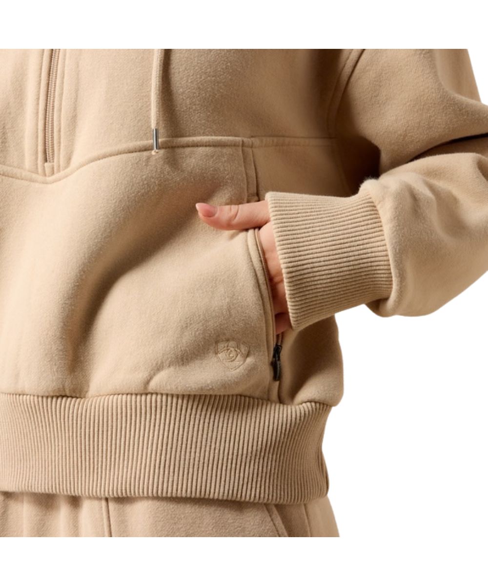 Close-up view of the zippered hand pockets and rib knit trim