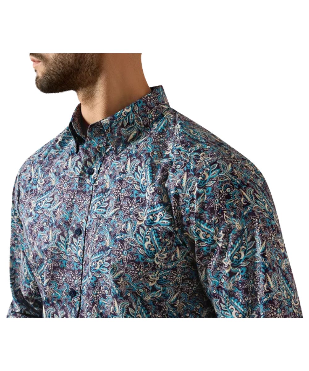 Close-up view of the blue and purple paisley printed men's button down shirt featuring the chest pocket with a hidden pen slot and the button down collar