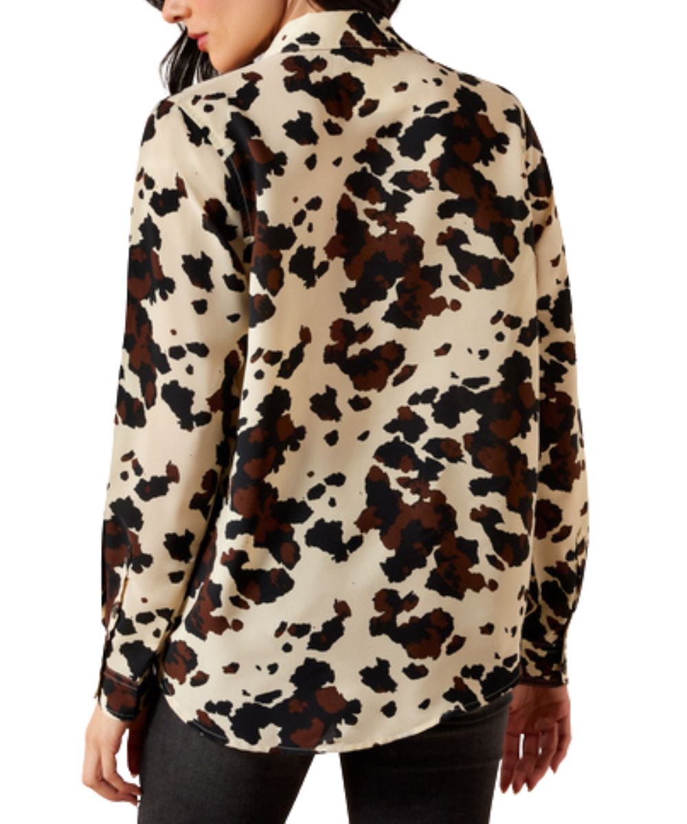 Back view of the women's long sleeve button down shirt featuring the cow print, slightly relaxed fit, and button cuffs