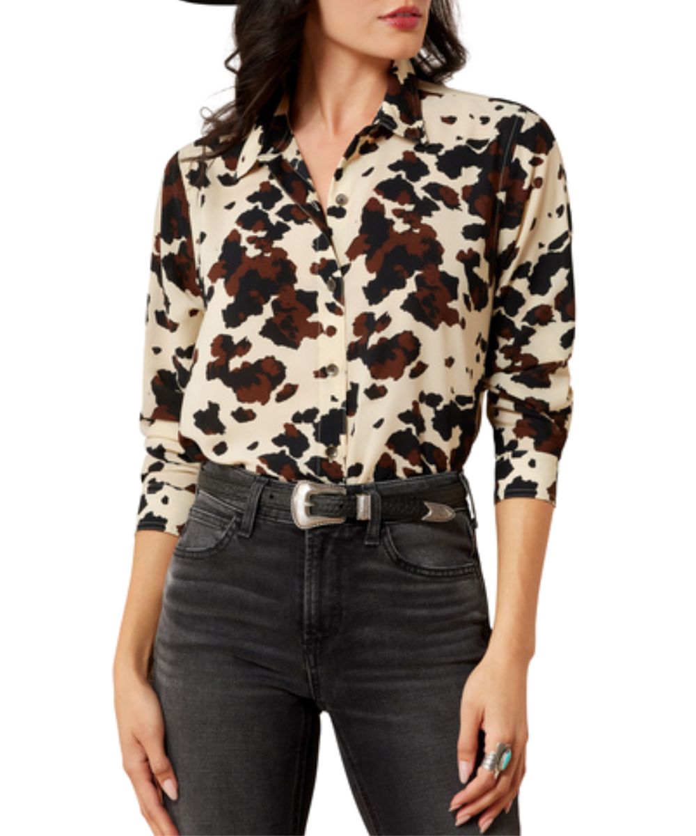 Front view of the women's white Ariat Homestyle Shirt featuring the cow printed design, button front closure, and spread collar