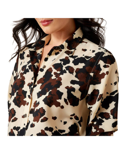 Close-up view of the women's cow printed button down, long sleeve, polyester blouse