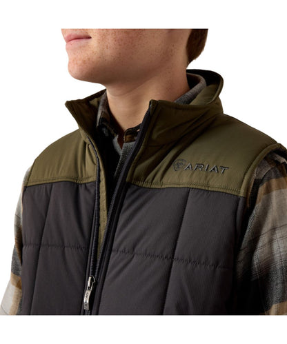 Close-up view of the color blocked detailing on the boy's phantom and olive insulated vest featuring the logo embroidery on the chest and back collar