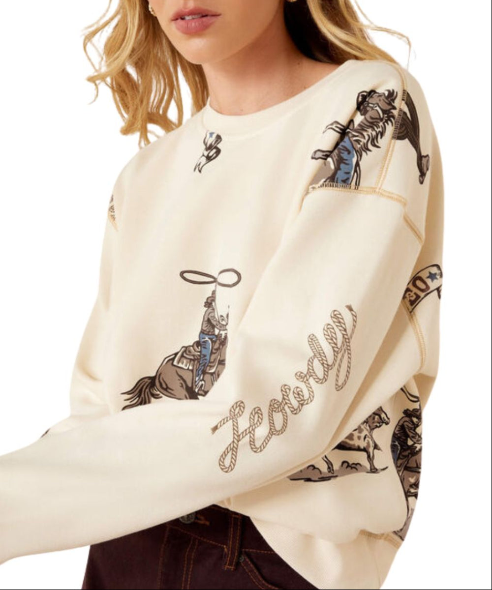 Close-up view of the dropped shoulders and text on the sleeve that reads: "Howdy"