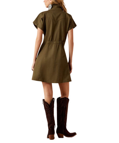A woman shown from the back wearing an olive green short-sleeve dress with a cinched waist and dark brown cowboy boots against a white background.
