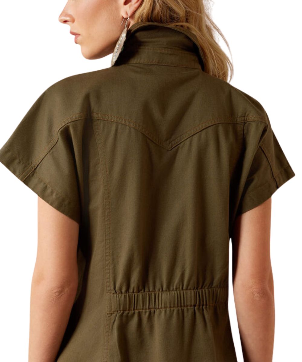 A woman shown from the back wearing an olive green short-sleeve shirt dress with a high collar and an elasticated back waist.