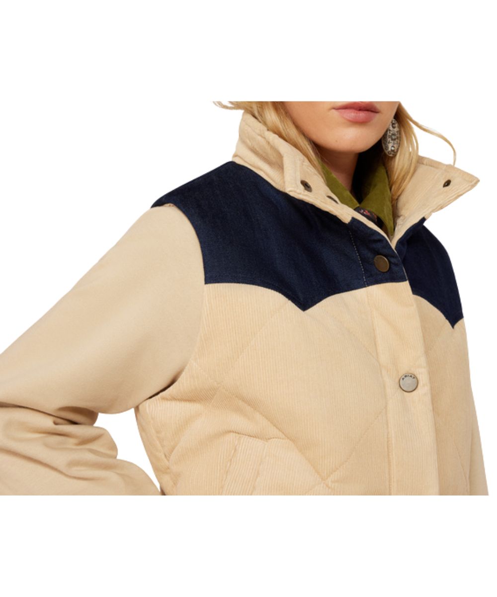 Close-up view of the women's insulated irish cream corduroy vest featuring the snap front closure, mandarin collar, and single point front western denim yokes