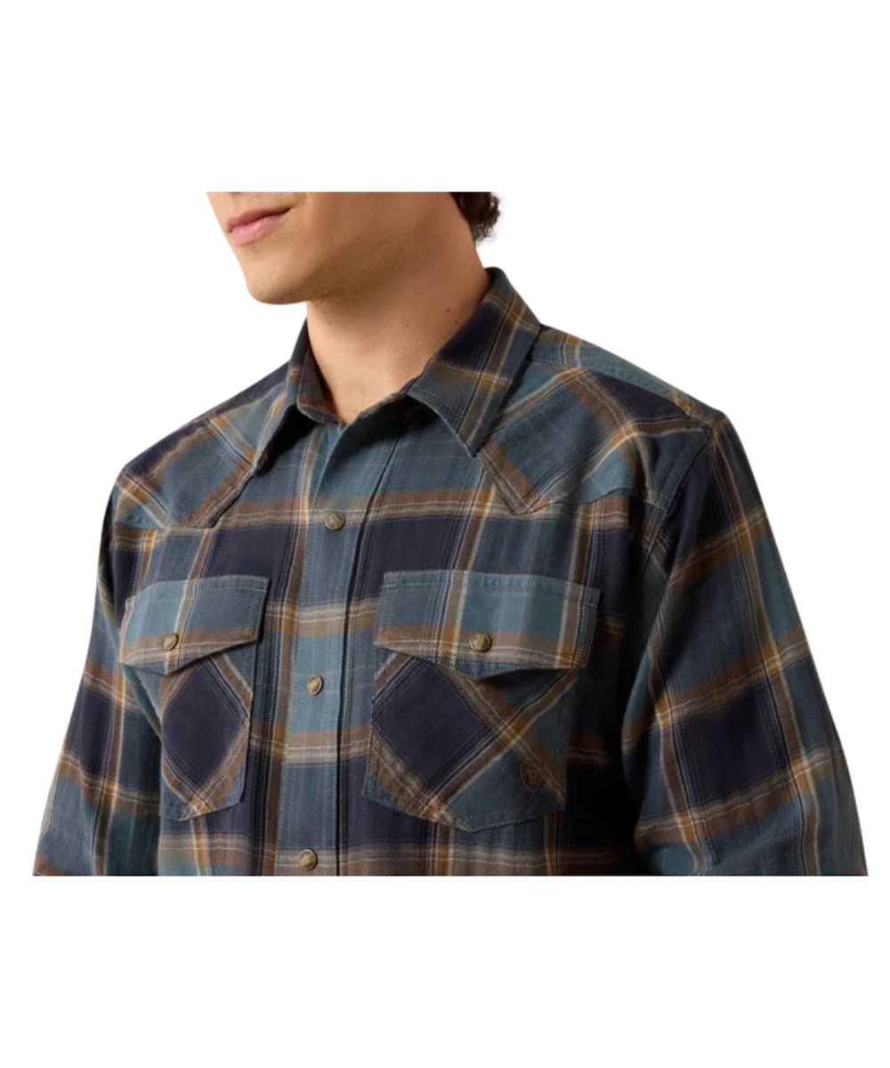 Close-up view of the plaid print, snap flap chest pockets, and single point front yokes