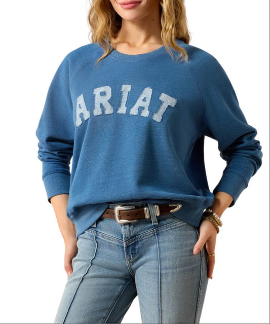 Front view of the women's Ariat long sleeve crewneck sweatshirt with "ARIAT" printed across the chest in white varsity-style fabric letter patches