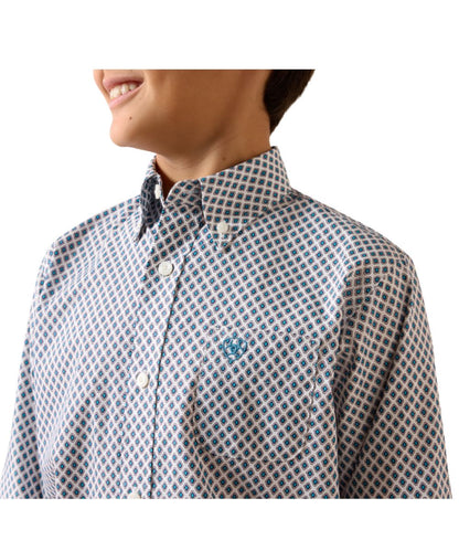 Close-up view of the boy's white long sleeve button down shirt featuring the blue geometric print and white buttons