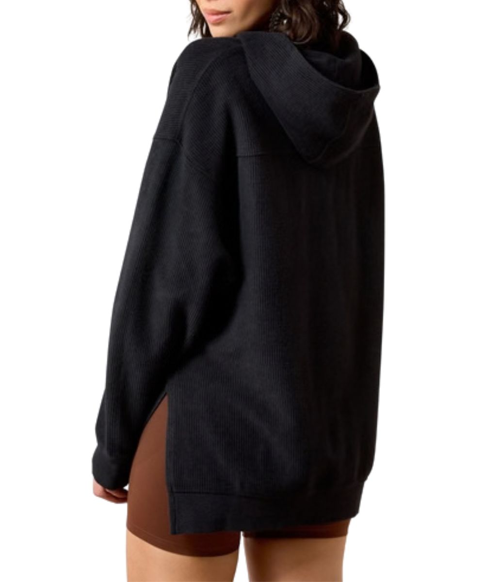 Back view of the women's black sweatshirt featuring the straight back yoke and side slits