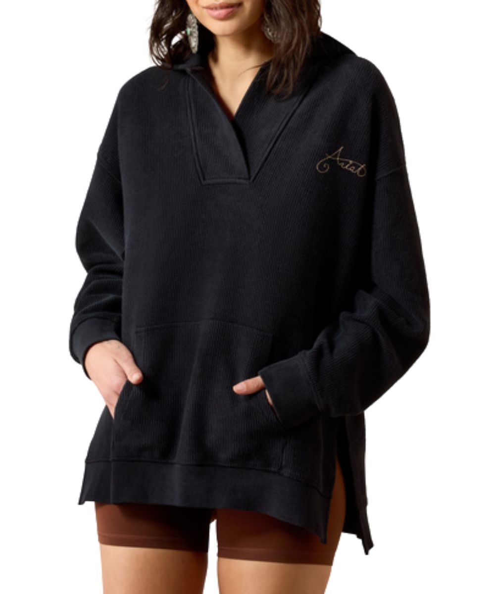 Front view of the women's black acid wash Ariat Valencia Hoodie featuring the long sleeves, effortless fit, hooded collar, v-neckline, kangaroo pocket, and side slits