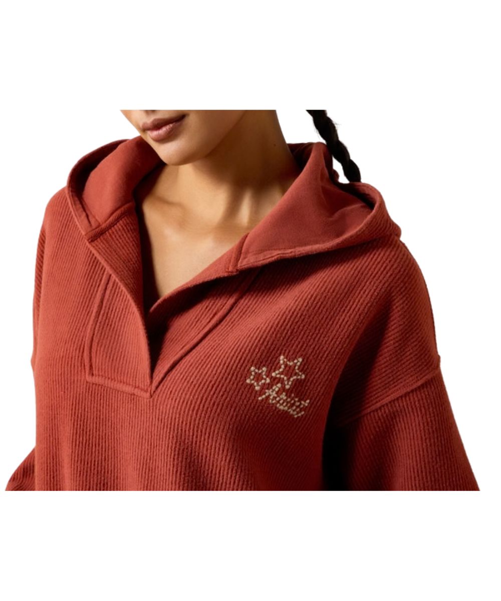 Close-up view of the women's soft terrycloth slouchy sweatshirt featuring the logo embroidery at the left chest with star accents