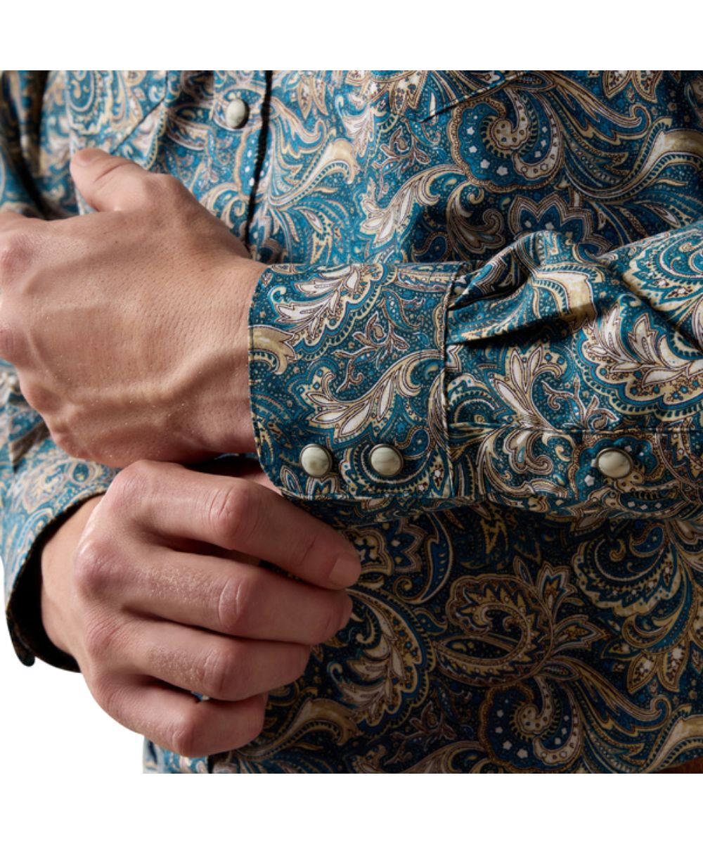 Close-up view of the double-snap cuffs with extended detail to easily roll up sleeves and the blue shirt with paisley print