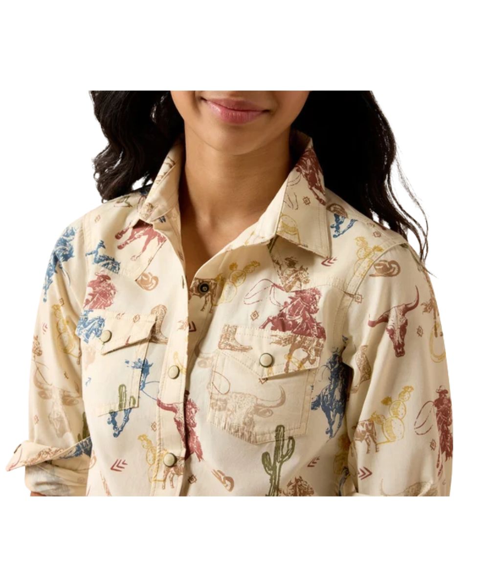 Close-up view of the girl's long sleeve pearl snap shirt featuring the western yokes on the front, and the single point snap flap chest pockets