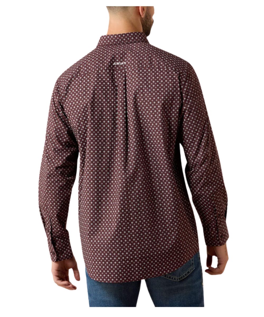 A man viewed from the back wearing a long-sleeve button-up shirt with a small white geometric pattern on a dark reddish-brown base, paired with blue jeans against a plain white background.