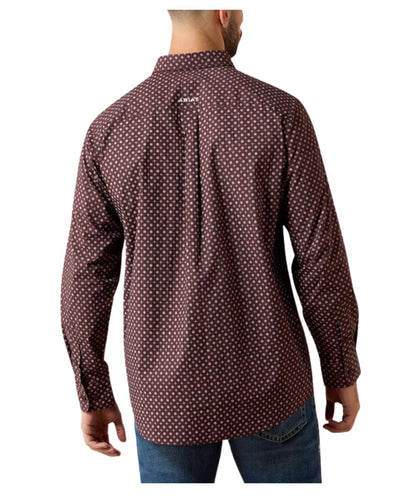 A man viewed from the back wearing a long-sleeve button-up shirt with a small white geometric pattern on a dark reddish-brown base, paired with blue jeans against a plain white background.