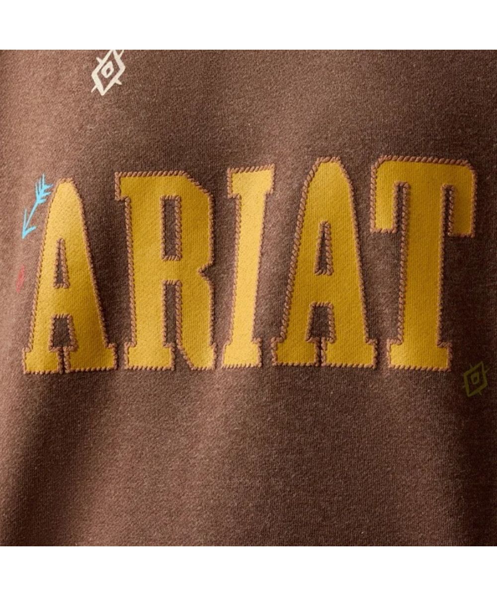 Close-up view of the yellow-toned logo screen print and arrow embroidered accents