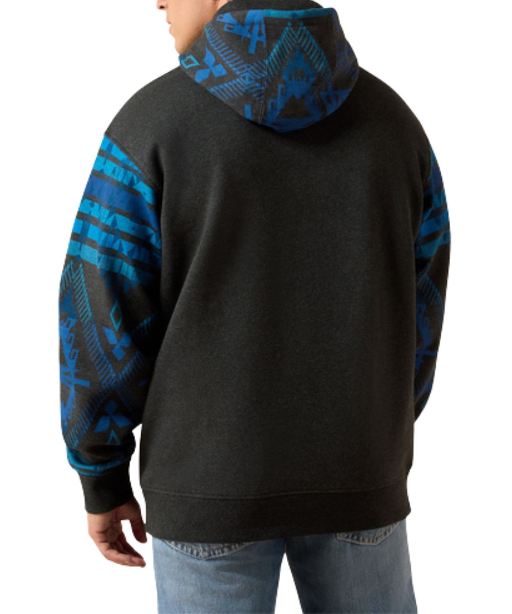 Back view of the men's long sleeve hooded sweatshirt in charcoal heather featuring the blue color blocked southwestern printed sleeves and hood