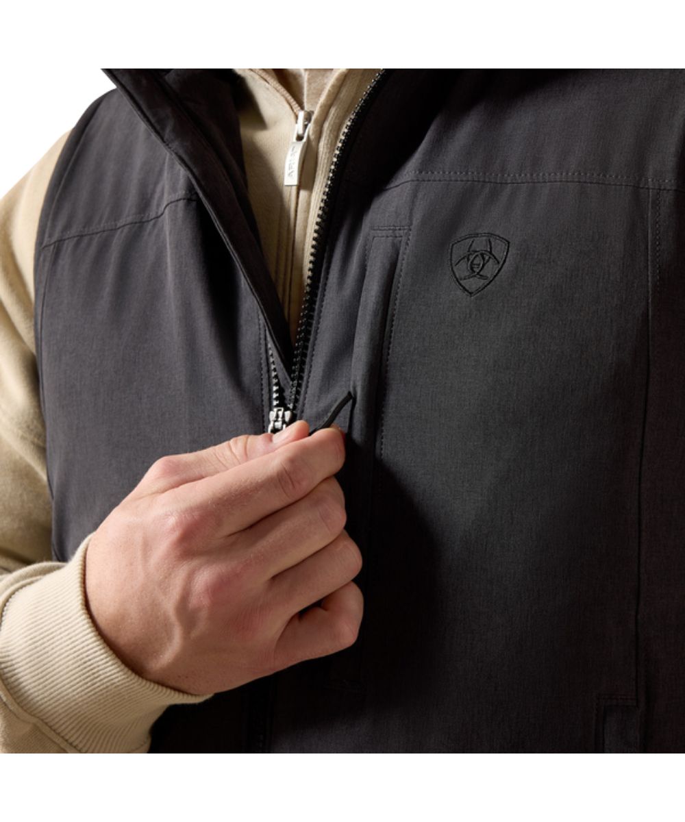 Close-up view of the zippered chest pocket and logo embroidery