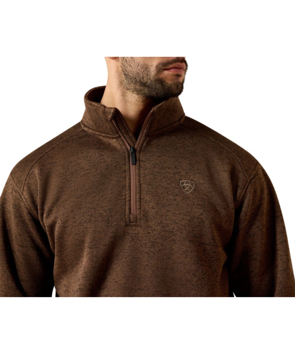 Close-up view of the men's carafe brown sweater featuring the 1/4 zip closure with logo pull tabs, Ariat shield logo embroidered at the chest, and mock collar
