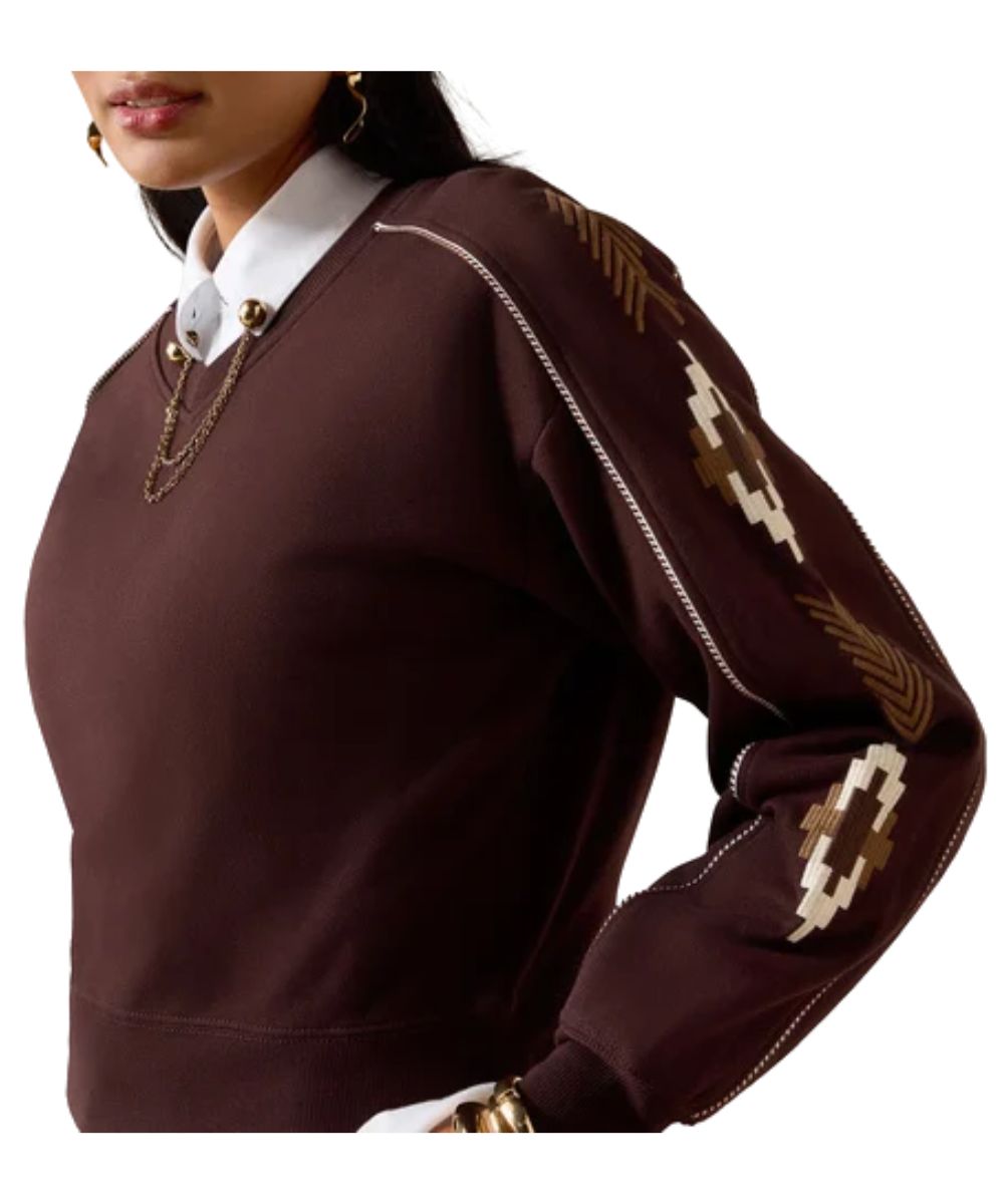 Close-up view of the southwestern embroidery on the women's chocolate plum/brown sweatshirt