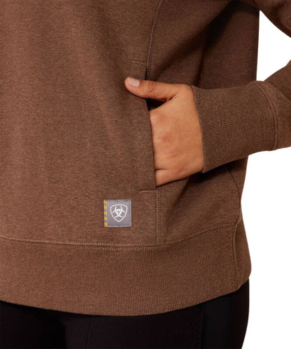 Close-up view of the women's brown crew neck sweatshirt featuring the welt hand pockets and ribbed hem