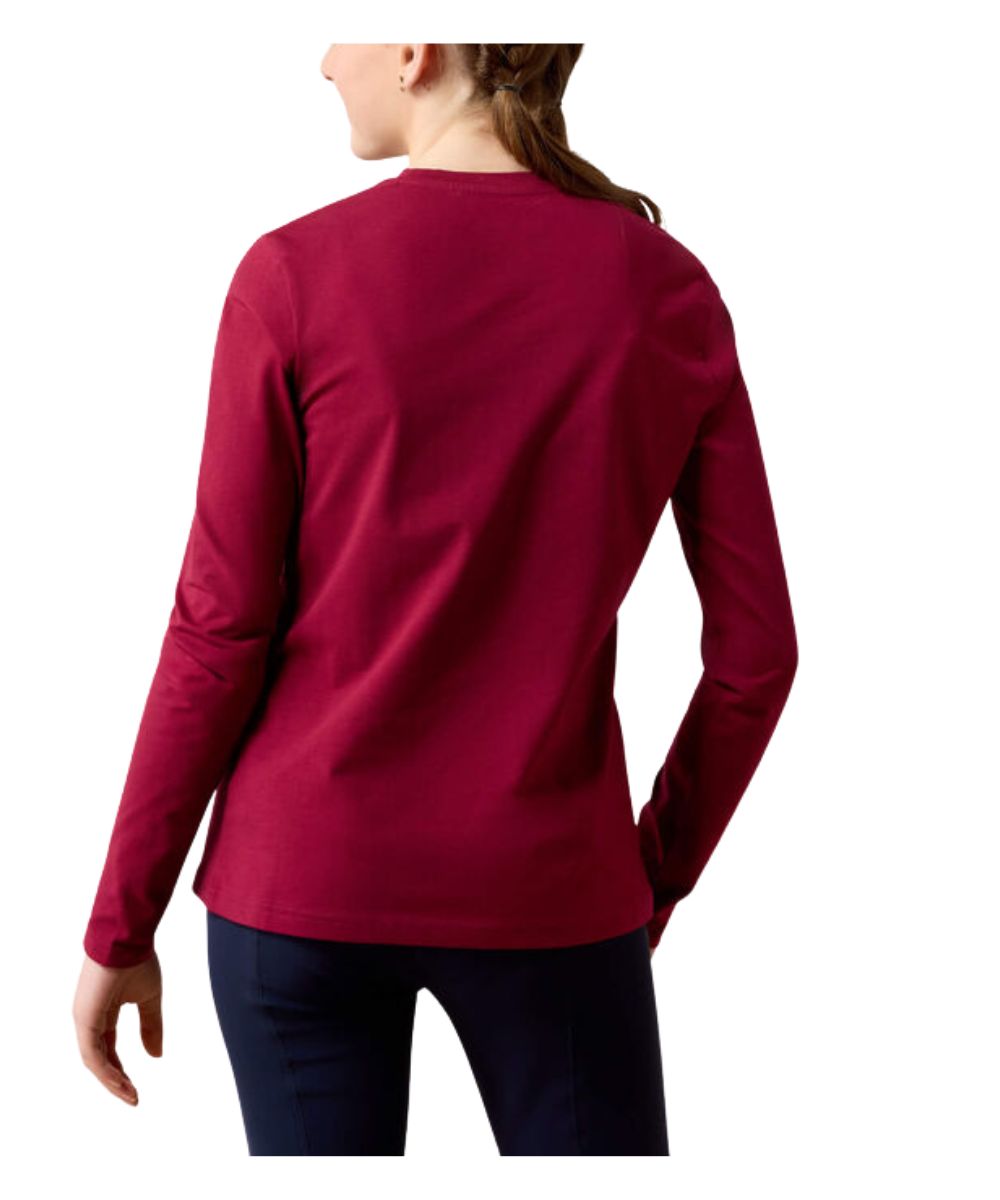 A girl shown from the back wearing a long-sleeve crewneck top in deep burgundy, paired with dark navy pants, against a plain white background.