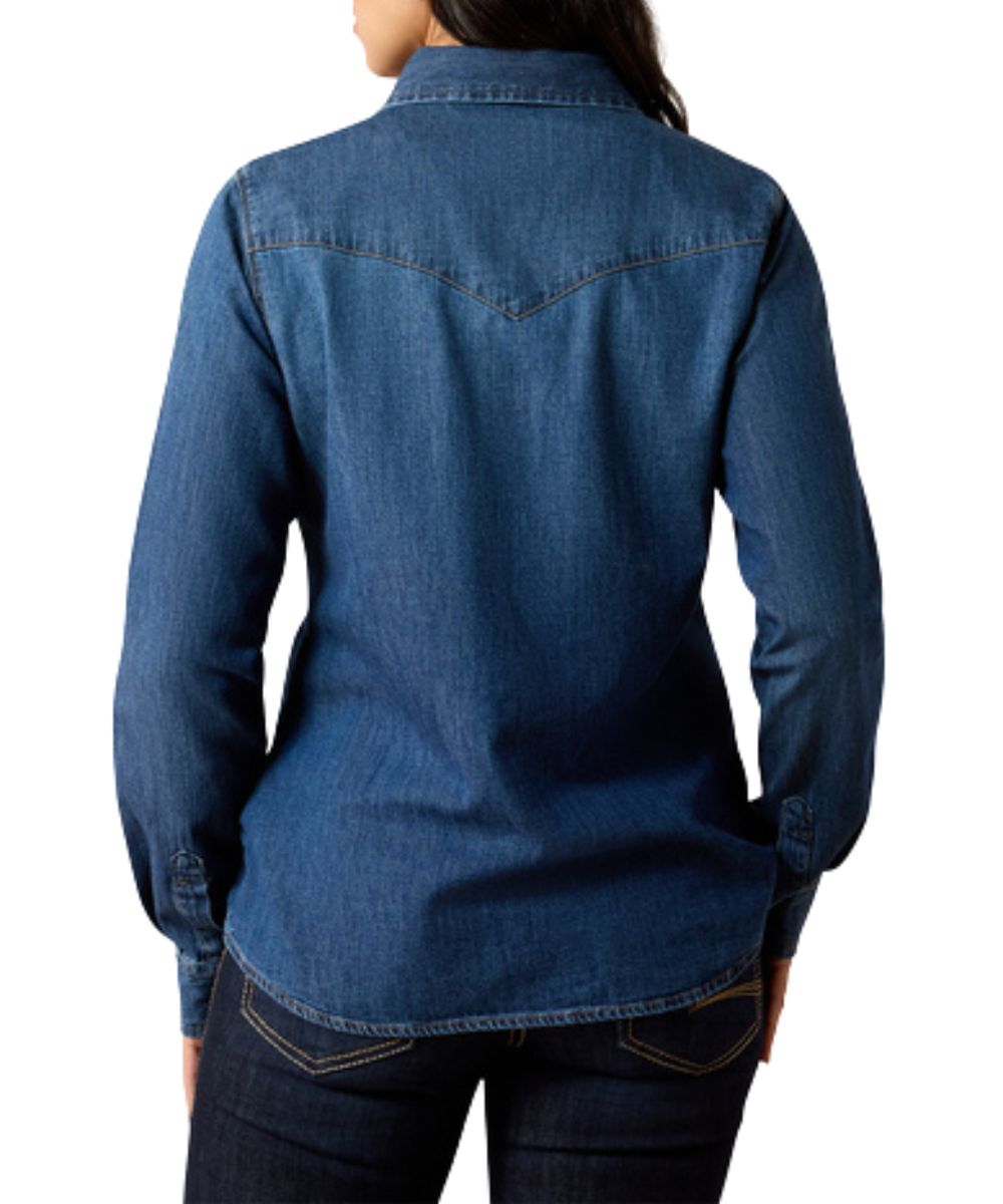 Back view of the women's long sleeve denim pearl snap shirt featuring the medium wash and western yokes