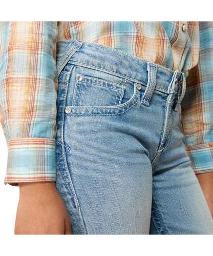 Close-up view of the front pockets featuring the zipper fly and slim fit on the girl's light wash jean