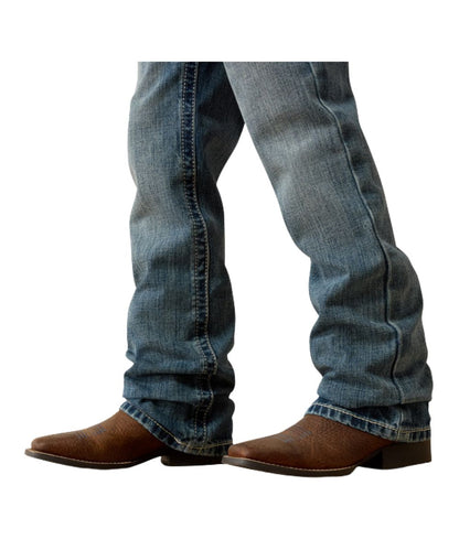 Leg view of the stackable boot cut leg in a medium durango wash on the boy's relaxed jean
