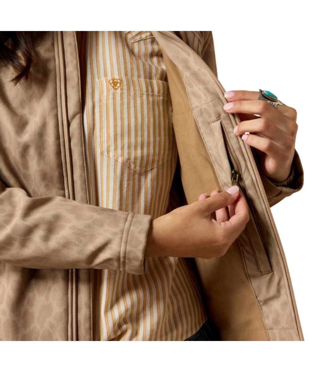 Interior view of the concealed carry zipper pocket inside the women's faded leopard softshell jacket
