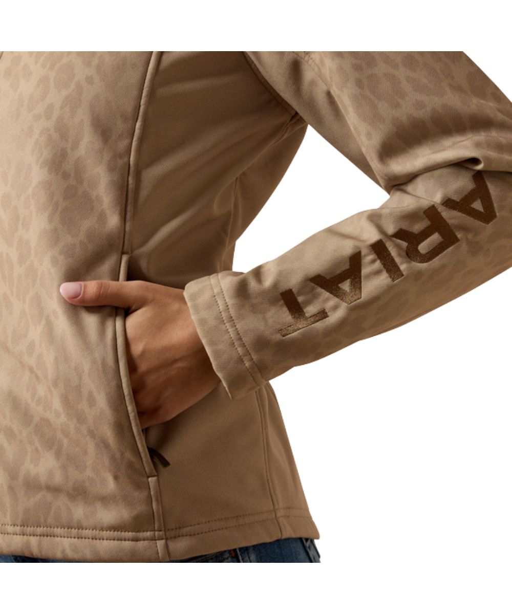 Close-up view of the faded leopard print, zippered hand pockets, and logo embroidery on the sleeve