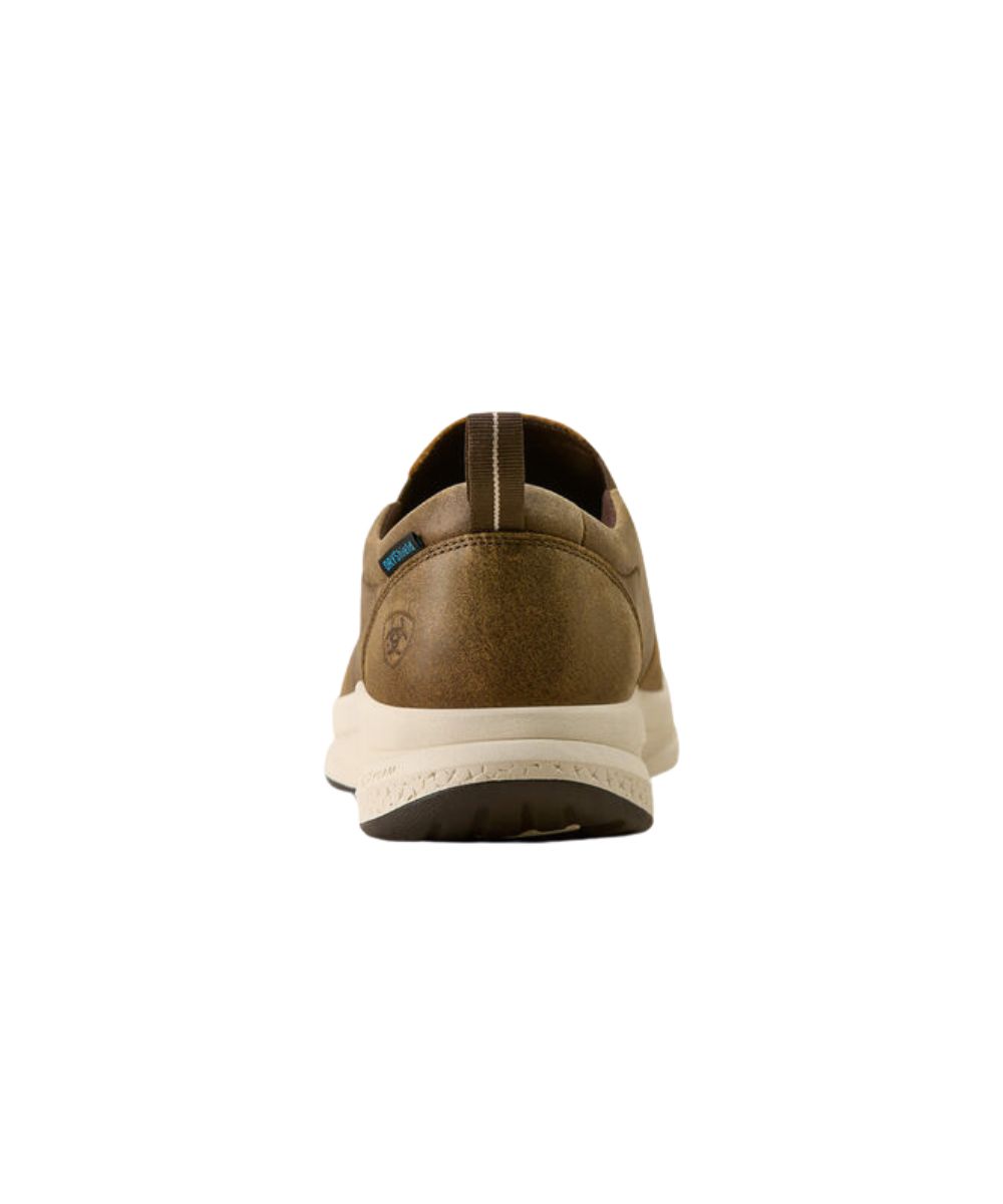 A single brown suede shoe shown from the back on a solid white background, featuring a cream-colored midsole and a small blue accent tag near the heel.