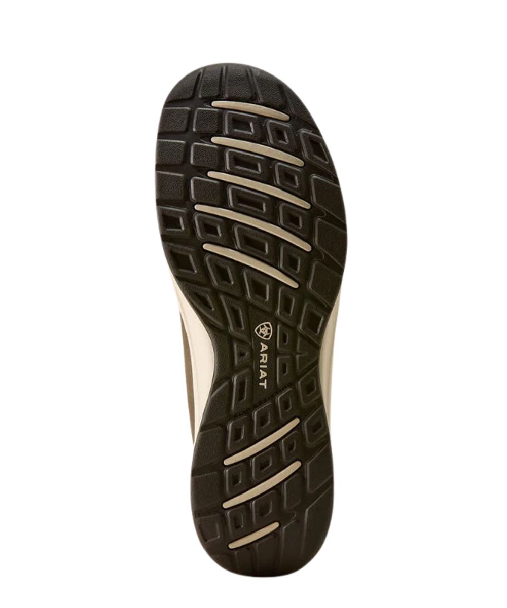 A close-up view of a shoe's textured black outsole with light beige lugs and the Ariat logo printed on the side, set against a plain white background.