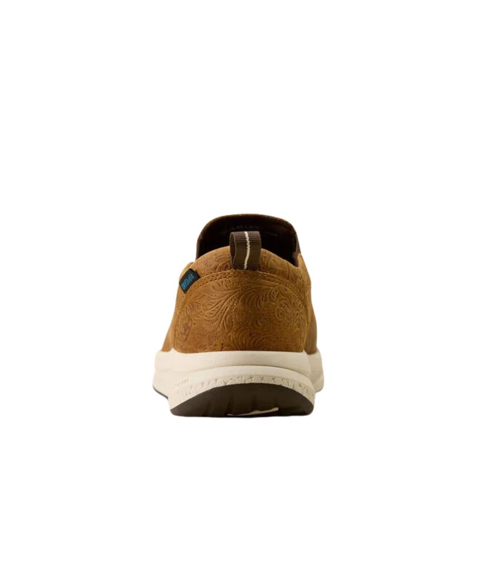 A view of the heel of a brown slip-on shoe with embossed floral detailing, a thick cream midsole, and a brown outsole, shown against a plain white background.