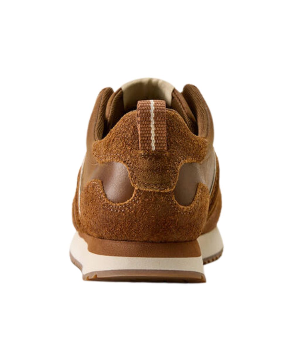 A brown suede and leather sneaker shown from the rear, featuring a pull tab and a cream-colored midsole.