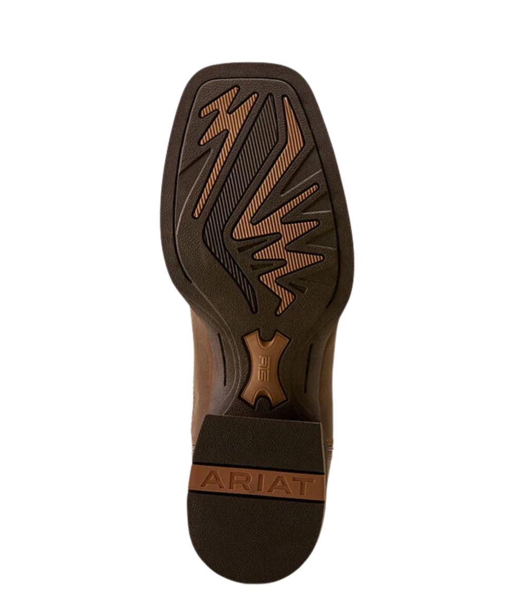 The outsole of a brown Ariat boot, showing a square toe with a textured tread pattern and the brand name 'ARIAT' embossed on the heel.