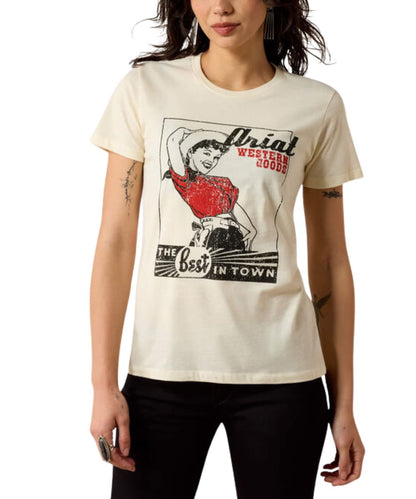 A woman wearing a cream-colored graphic t-shirt with a vintage-style western print that reads 'Thial Western Boots' and 'The Best In Town'.