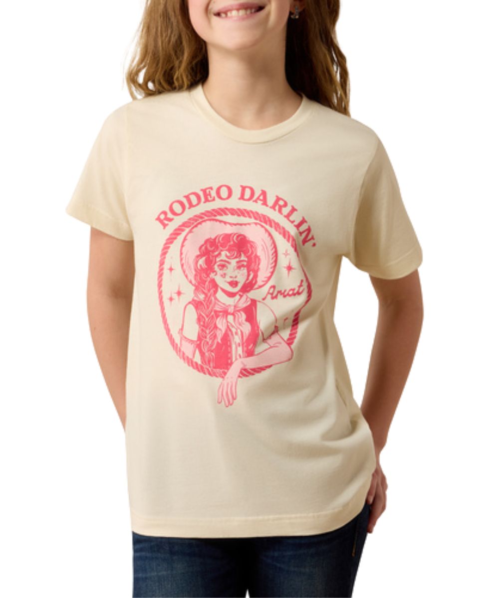 Front view of the girl's Ariat Rodeo Darlin' T-Shirt in a natural color featuring the cowgirl graphic on the front that reads: "Rodeo Darlin'" in pink