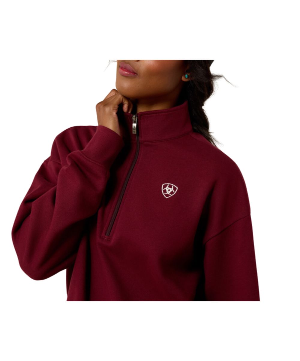 Close-up view of the women's wine sweatshirt featuring the contrast logo embroidery at the left chest